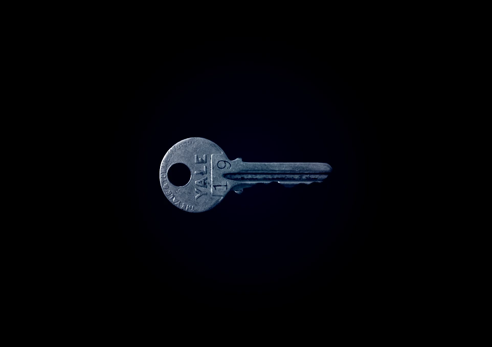 closeup photo of Yale 19 key against black background